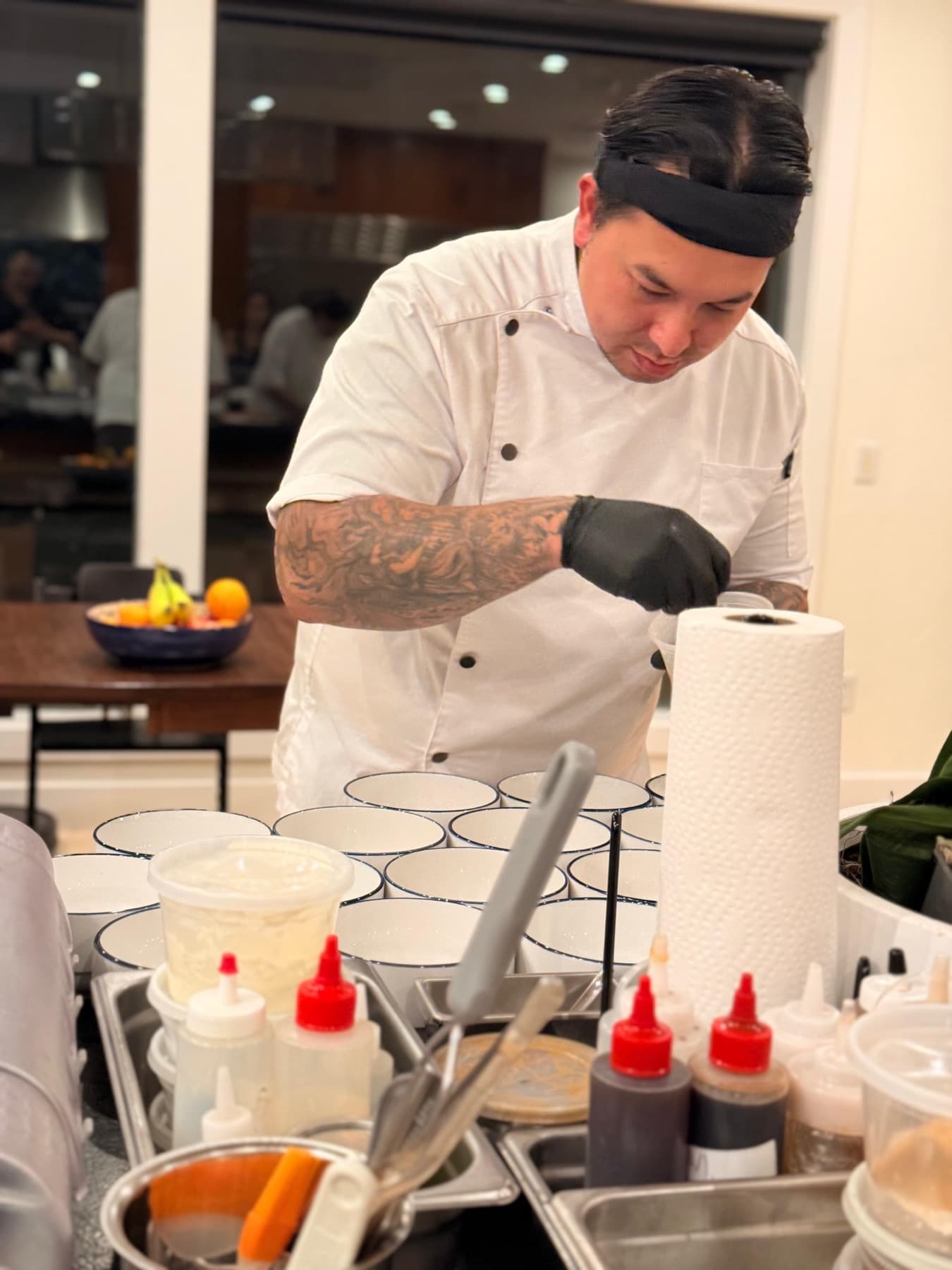 Chef plating at an Oku Duka dinner