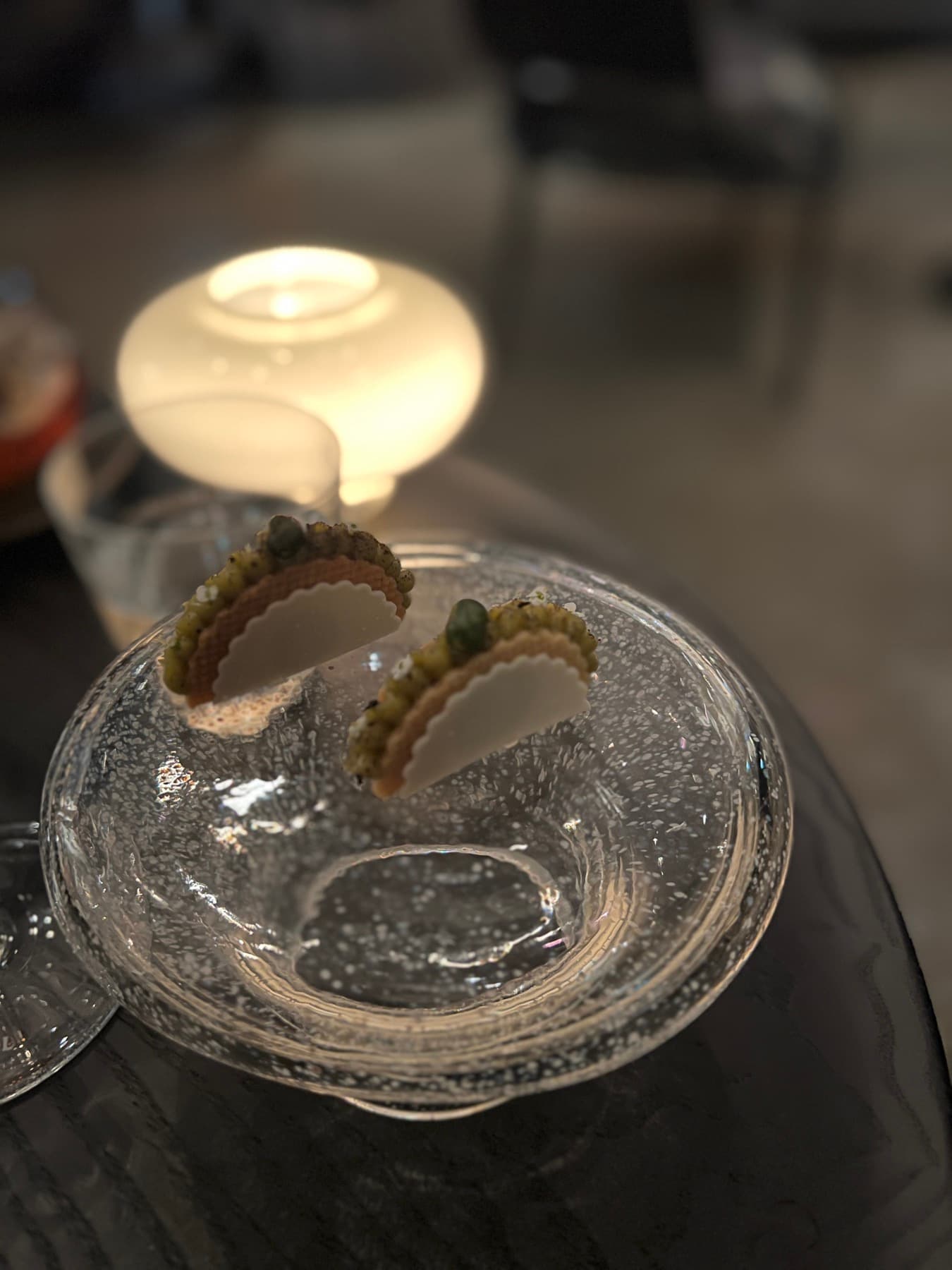 Miniature tacos served in a bubbled glass bowl